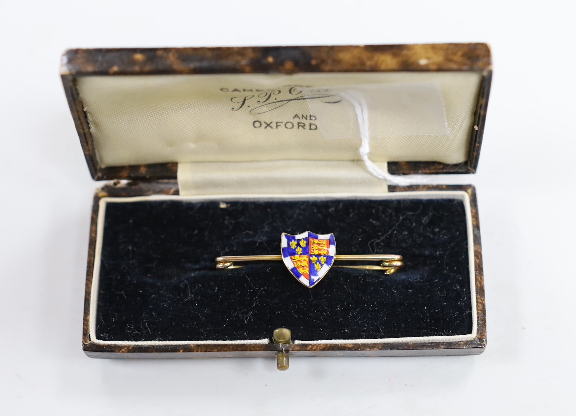 An early 20th century 9ct and polychrome enamel shield bar brooch, depicting the Royal Arms of England, 41mm, gross weight 2.9 grams.